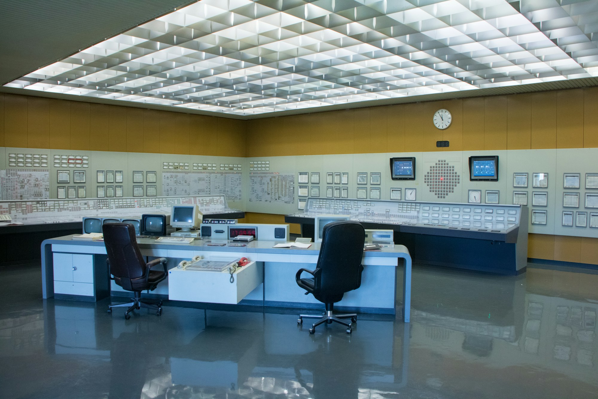 An operations control room with desks and screens